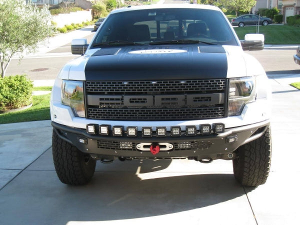 Addictive Desert Design 2010 - 2014 Ford Raptor Race Series R Front Bumper with ADD Logo and Aluminum front valance panel with mount for 10 single lights on top and Winch with dual 4 LED mounts and SRM flush mounts in side of aluminum in Hammer Black